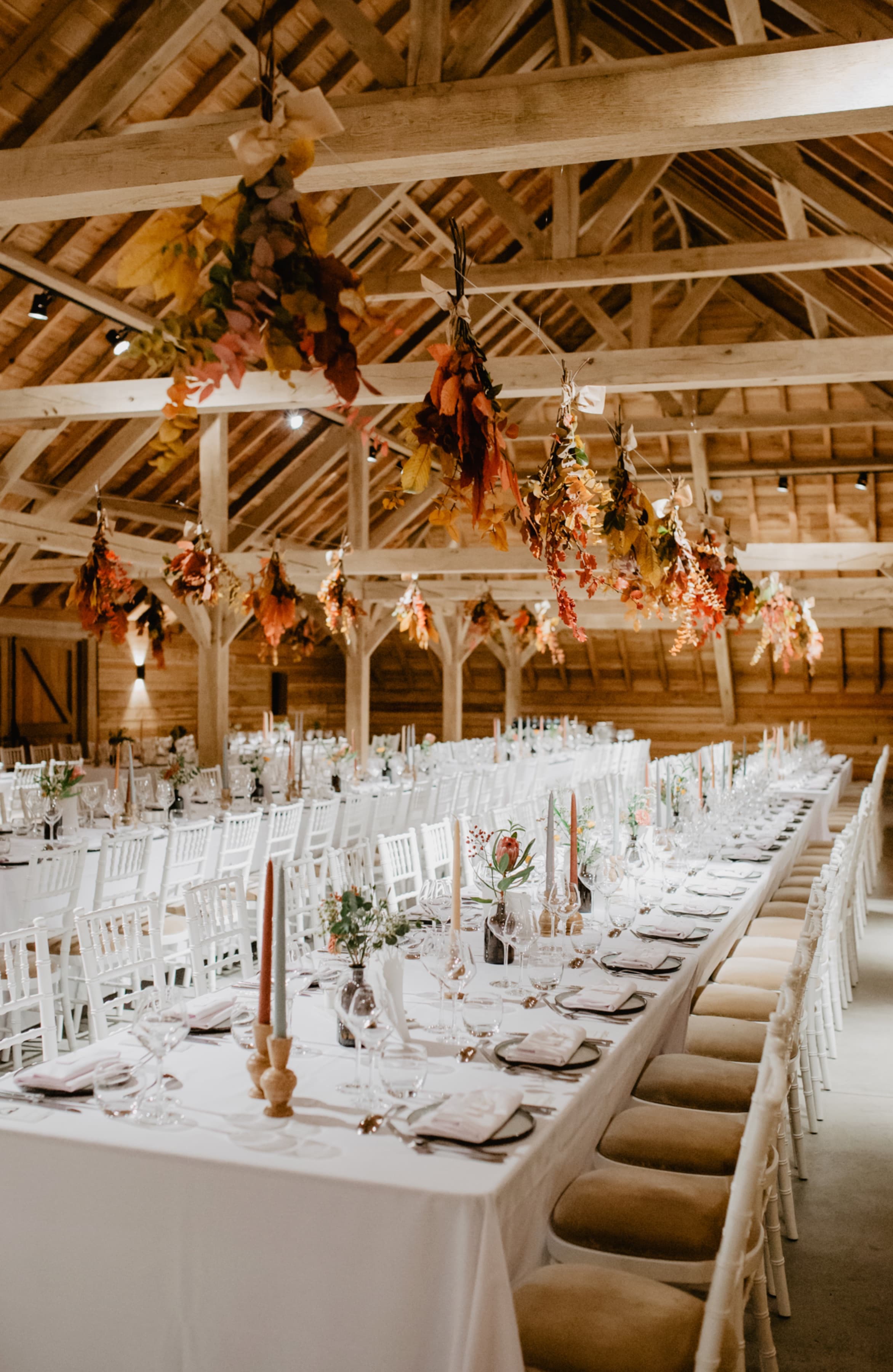 table setting with candles and hanging leafs