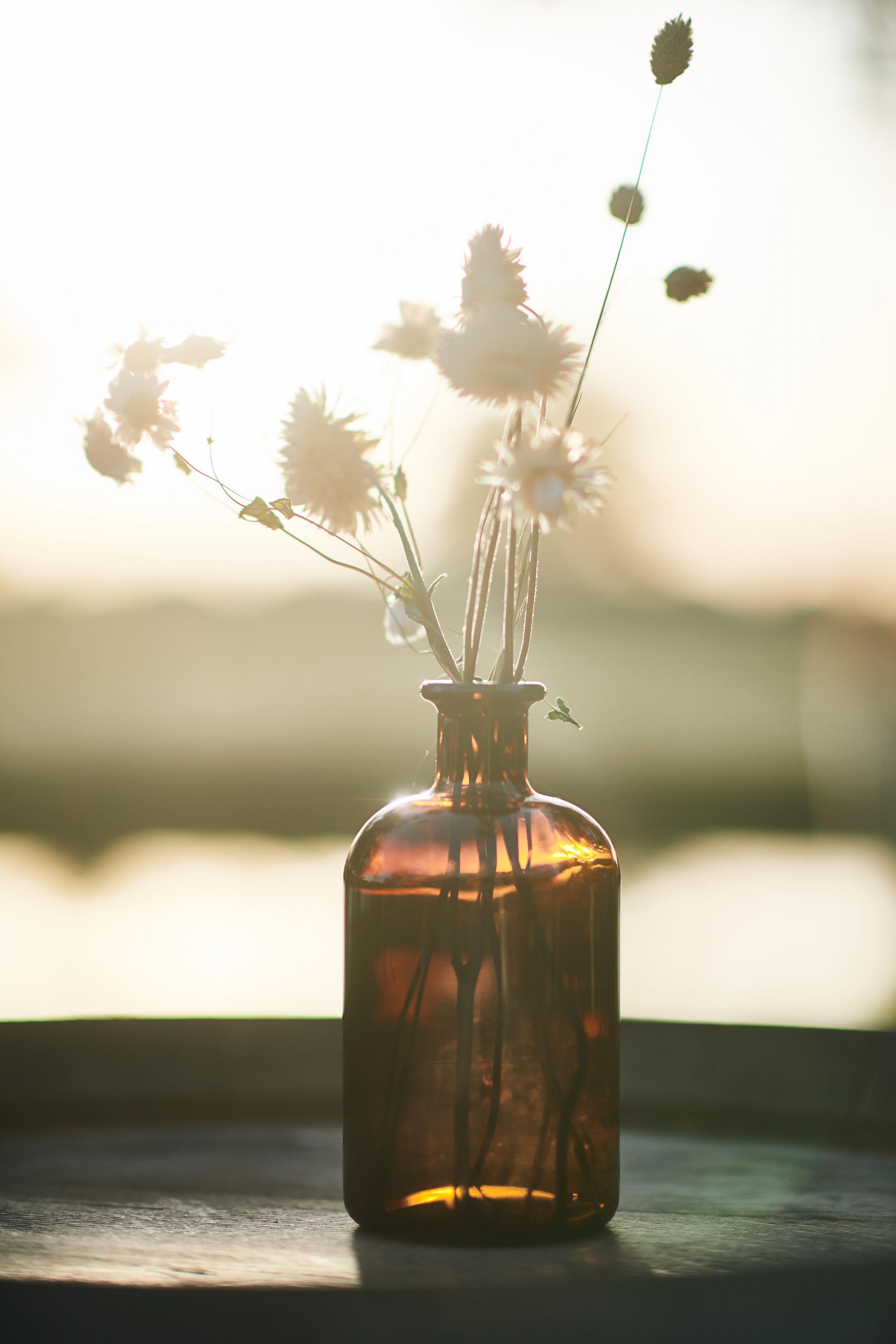 brown vase with flowers